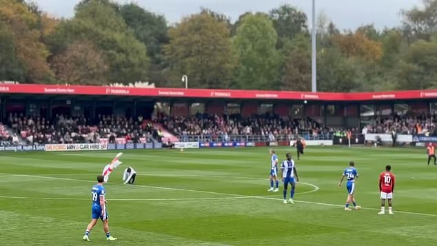 Gary Neville faces furious backlash as angry fans invade pitch at Salford stadium to protest his comments on the British flag