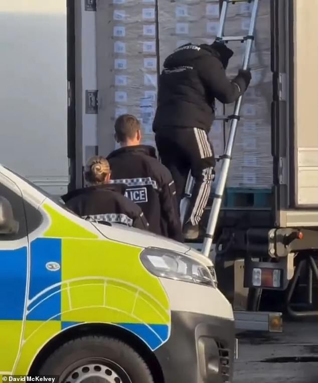 Eight migrants wearing designer tracksuits are found by police packed inside a lorry at M25 Waltham Abbey as chaos erupts at the busy truck stop