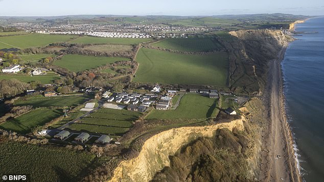 Environmental group raises alarm as developers push forward with expensive cliff-top lodges overlooking the unstable Dorset coastline
