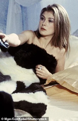 Rosamund Pike dazzles fans in a bright yellow gown as she attends the Now You See Me premiere in New York City